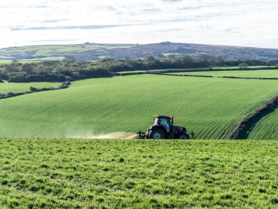 Farm Safely Podcast with Brian Aherne, with tractor spraying slurry in a green field